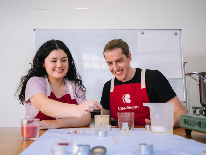 A man and woman are making handmade candles 